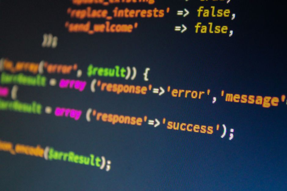 Laptop screen showing API error codes and JSON response data for troubleshooting